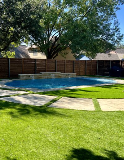 Texas Turf Design outdoor living area with pool and landscaping.